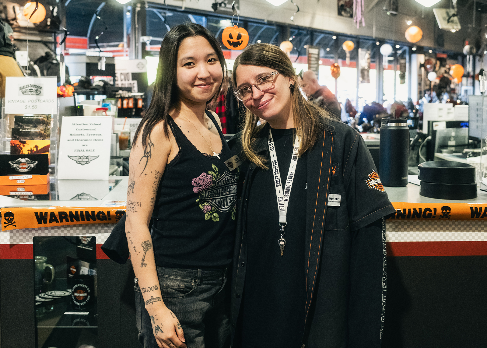 Two employees pose for a photo inside the showroom at Harley-Davidson of Nassau County.