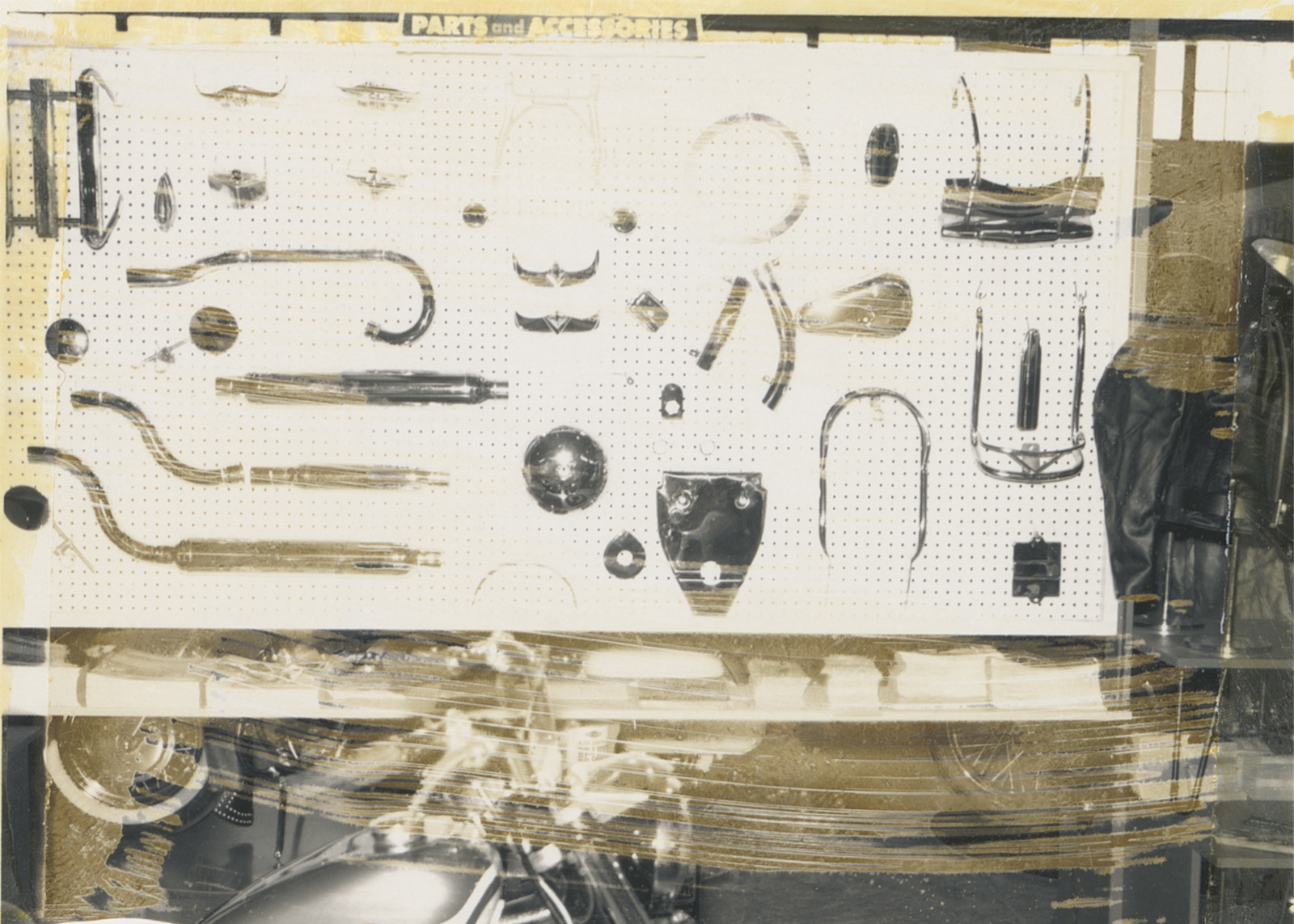 A vintage photograph showing the inside of the Harley-Davidson exhibit displaying parts and accessories