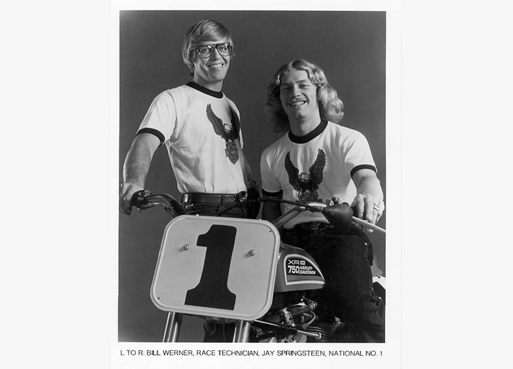 Black-and-white portrait of Jay Springsteen and Race Technician Bill Werner seated on a number 1 Harley-Davidson race motorcycle