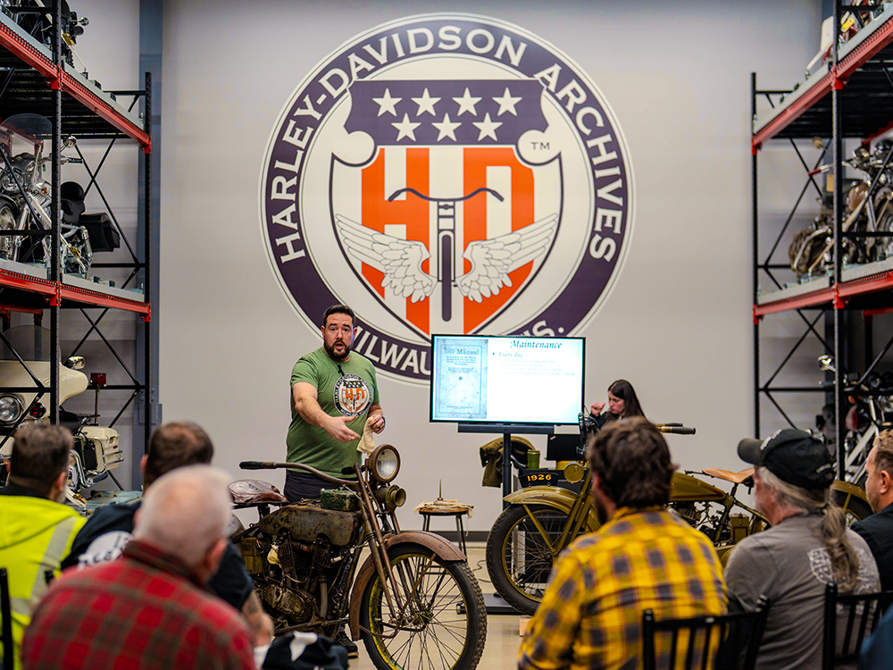 Presenter leading motorcycle history talk at Harley-Davidson Archives