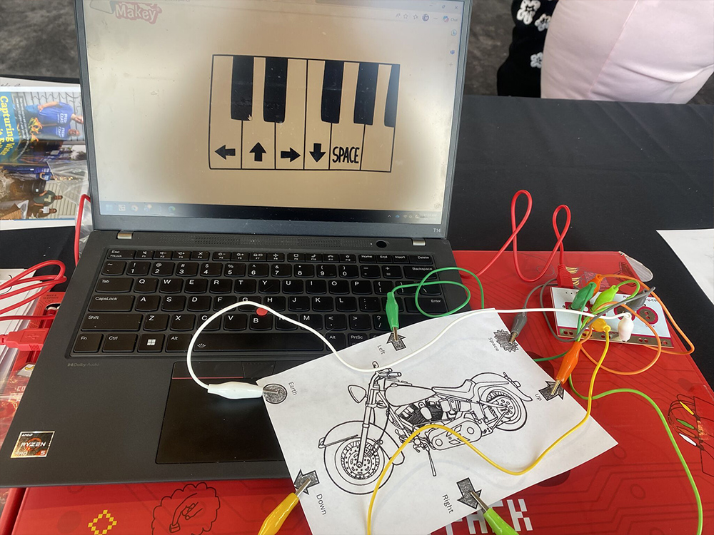 Interactive motorcycle circuit project connected to laptop activity station