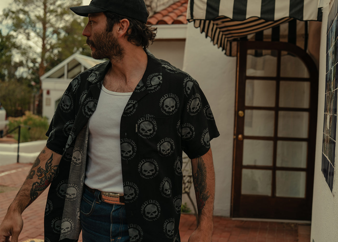 Man in a black Harley-Davidson skull button-up shirt