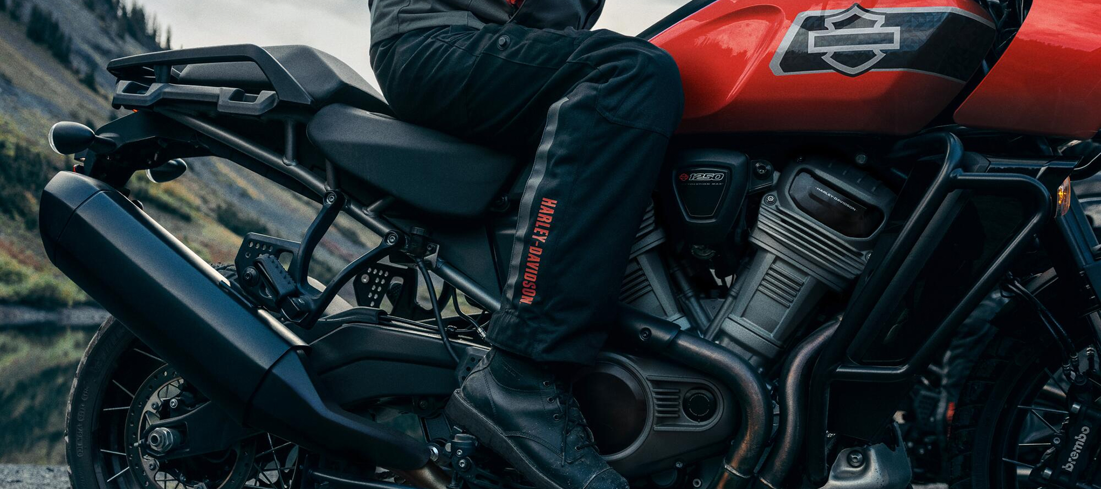 Rider stands with Pan America Special on gravel