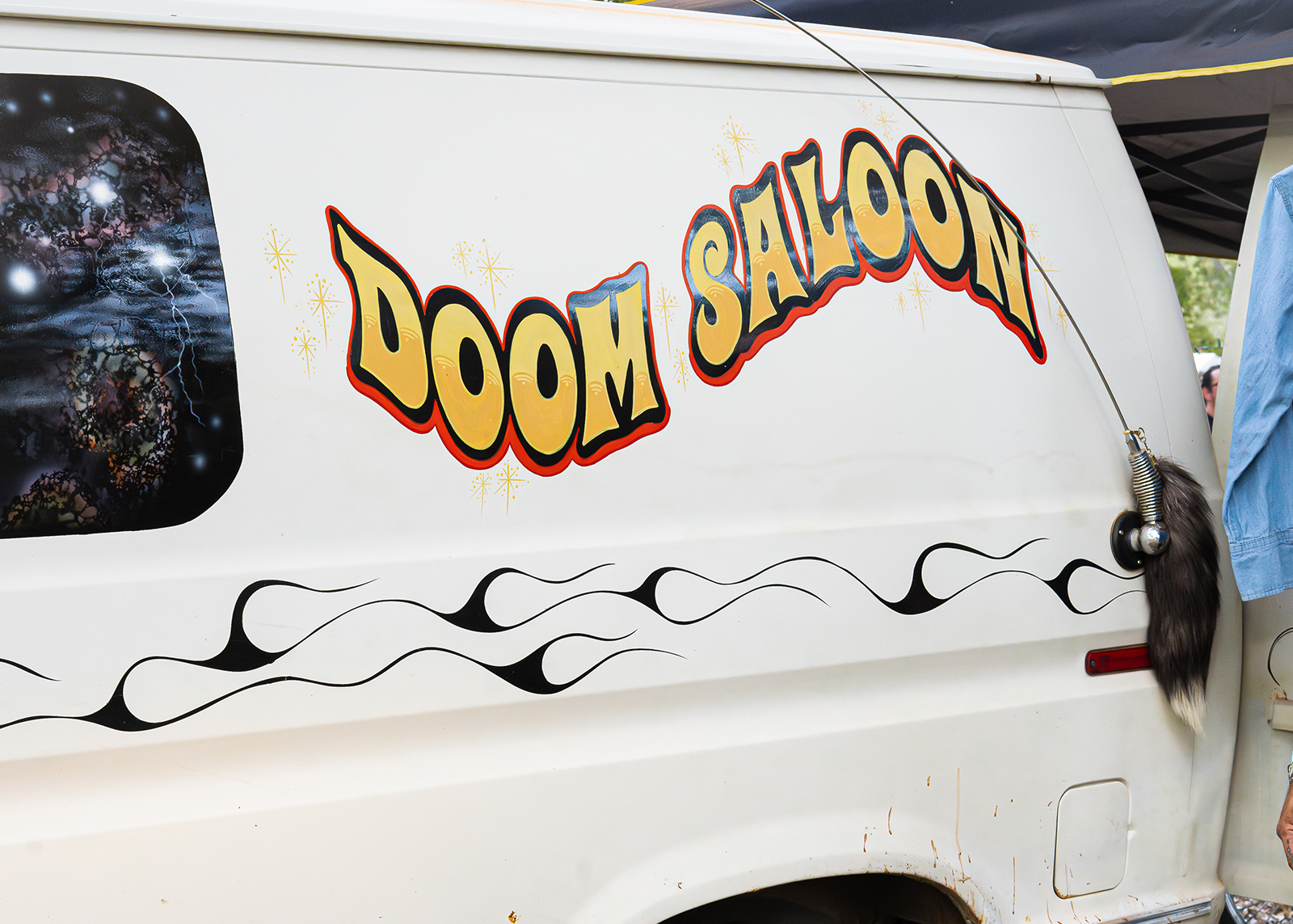 White van with "Doom Saloon" painted on the side