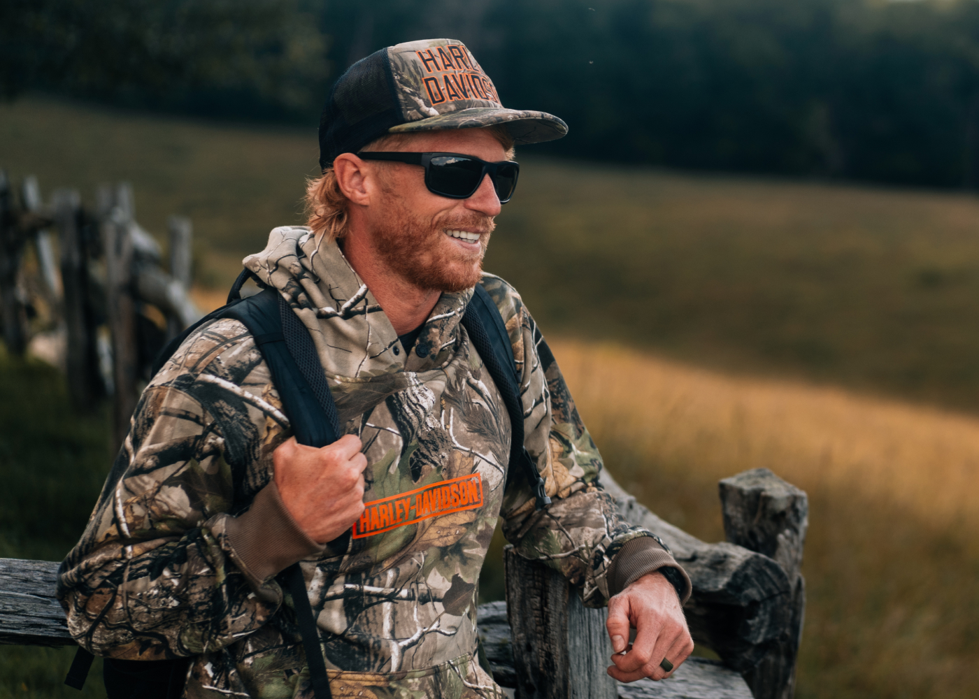 man in camo Harley-Davidson x Realtree hoodie and trucker hat