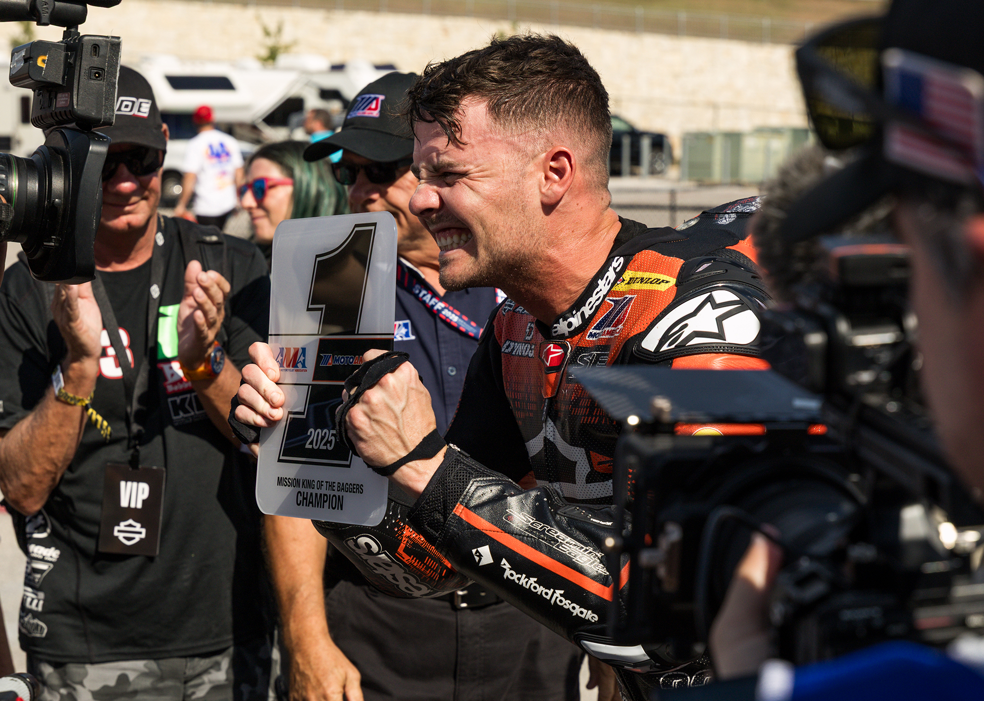 Kyle Wyman grins while showing off the number one plate after winning the 2025 King Of The Baggers championship.