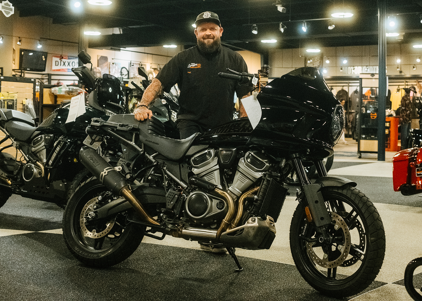 Shawn Wells, the White Lightning Harley-Davidson General Manager, Poses with a motorcycle on the showroom floor.