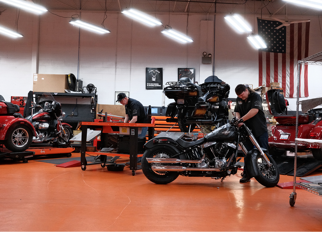 Two technicians work inside the service department at Kegel Harley-Davidson