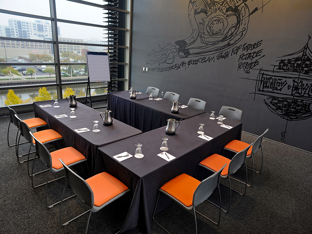 Conference table setup with notepads and chairs in modern meeting space