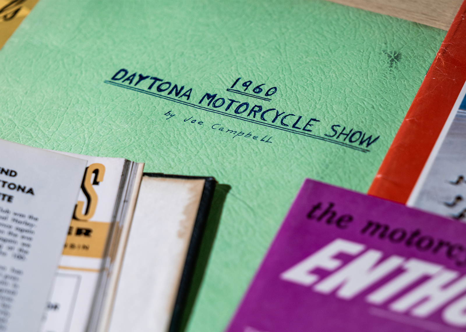 Vintage motorcycle documents including a 1960 Daytona Motorcycle Show booklet written by Joe Campbell
