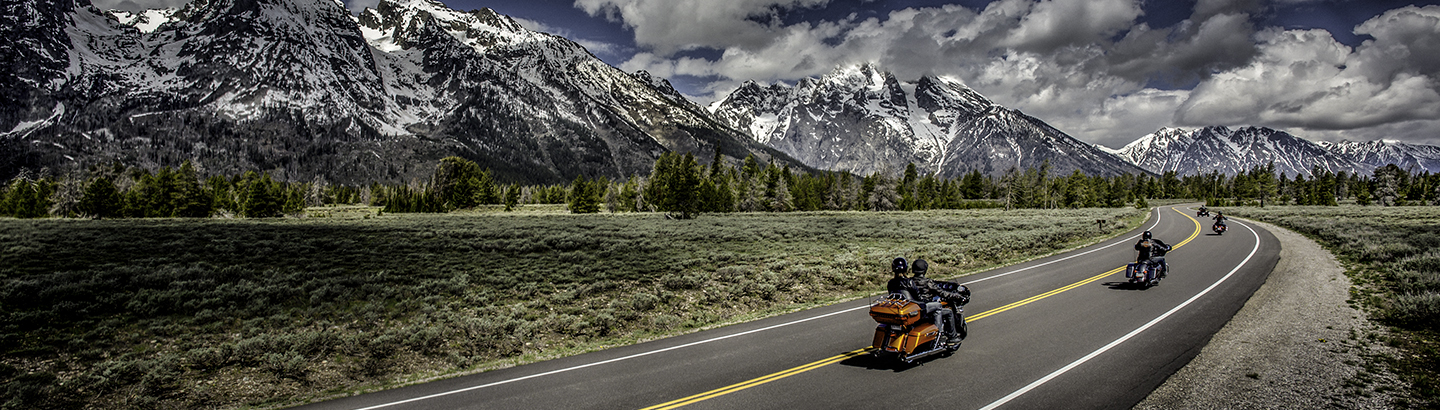 motorcycles riding on highway through mountians
