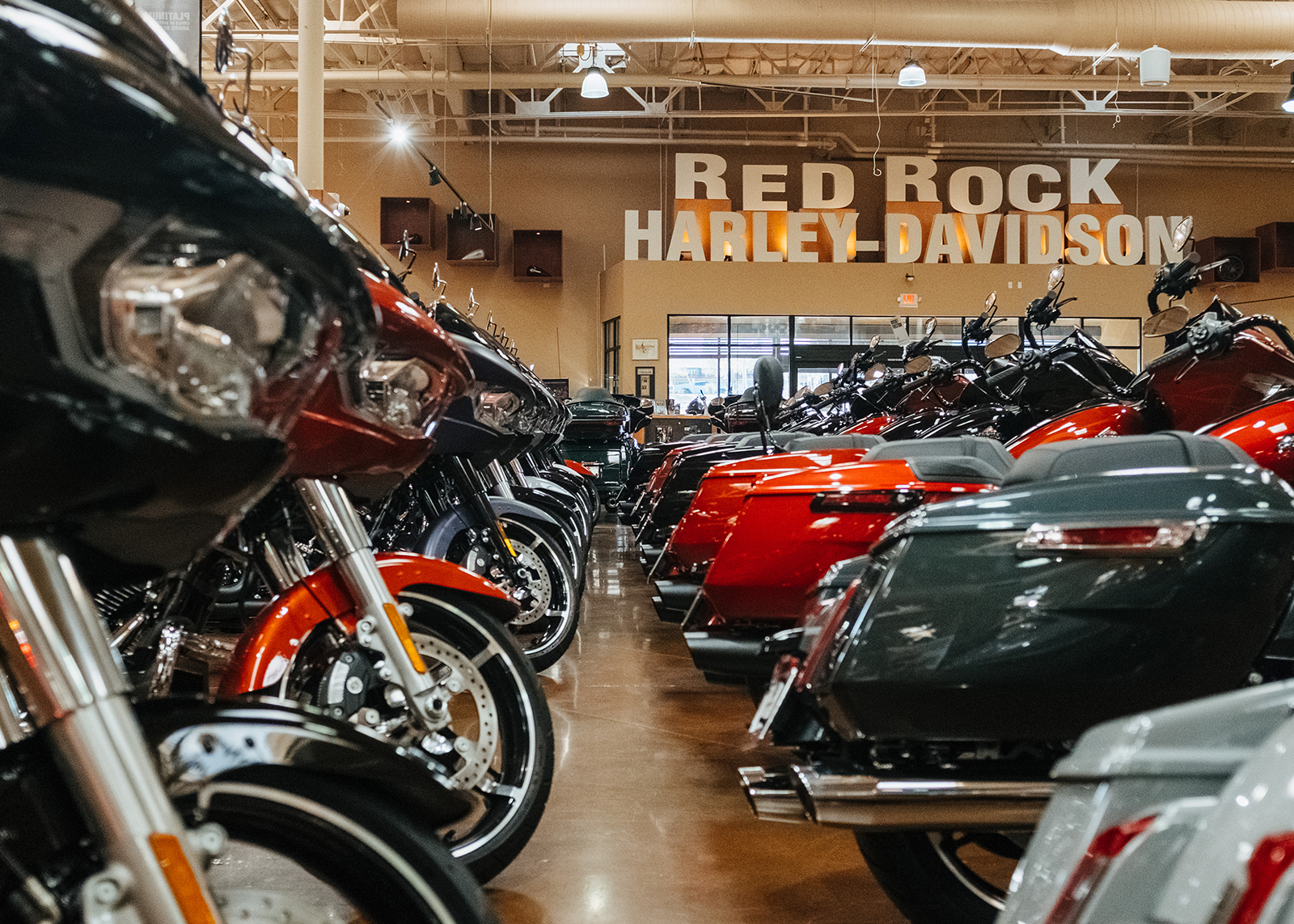 Motorcycles lined up on the showroom floor of Red Rock Harley-Davidson dealership.