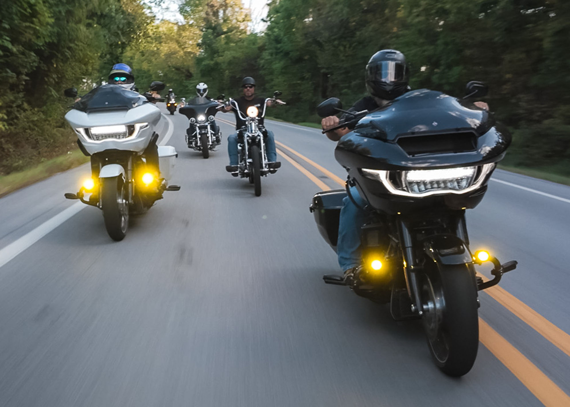 A group of riders weave their way through the mountains 