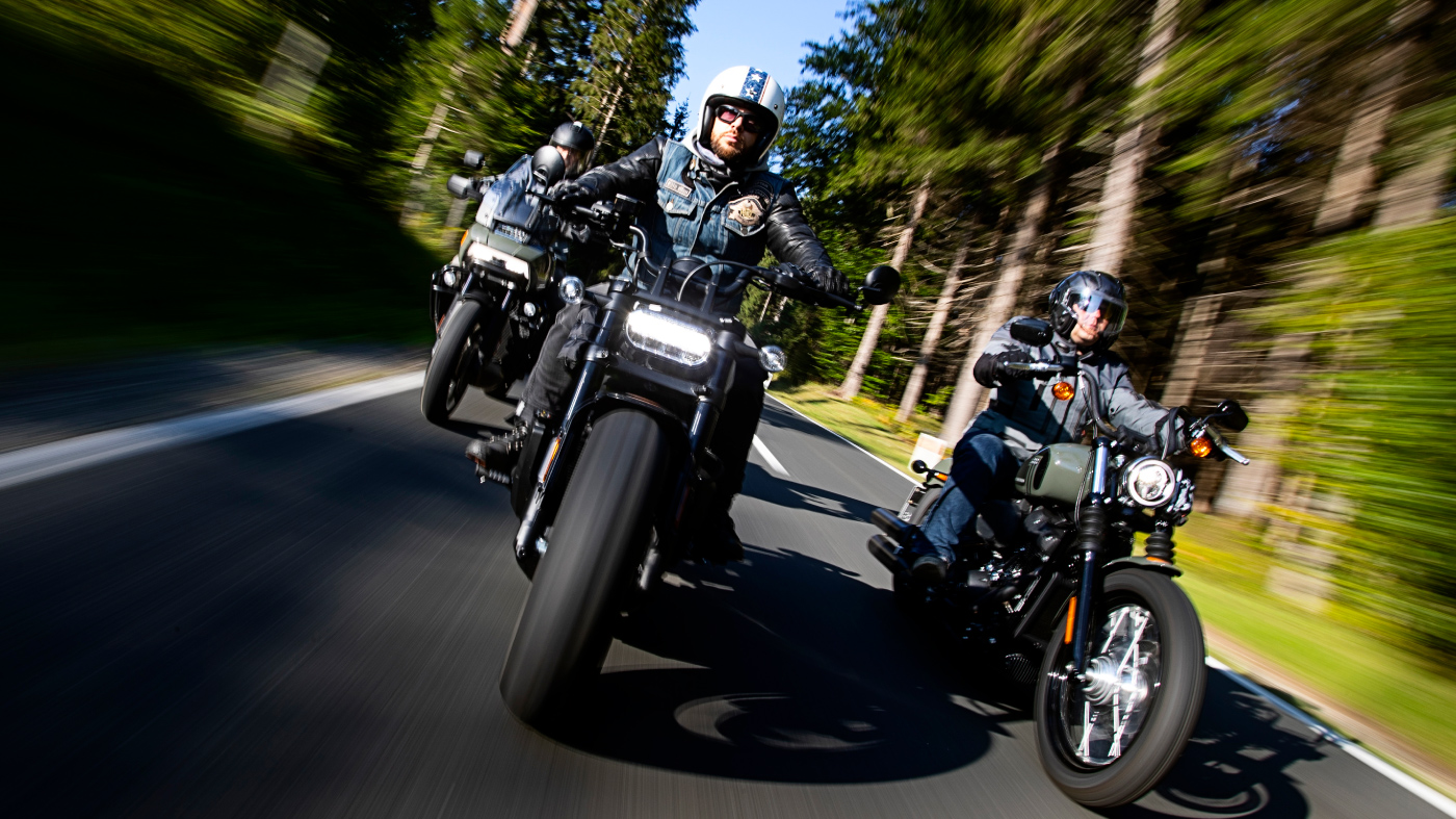 Motorcycles ridden on a wooded road