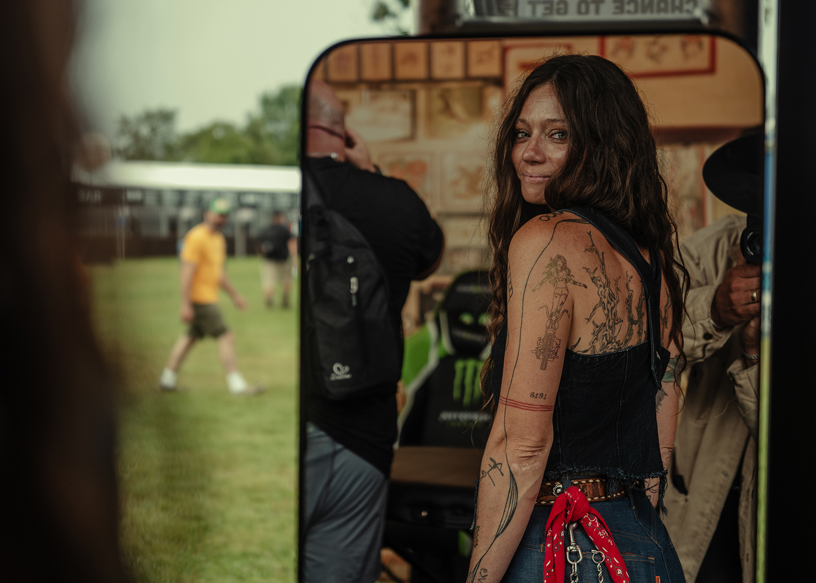 A women looks at her new tattoo in a mirror
