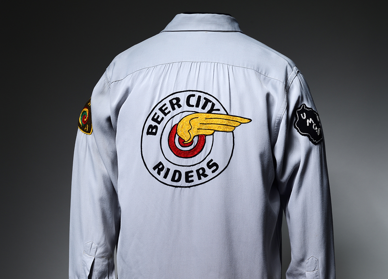 Gray motorcycle club jacket displaying a large embroidered Beer City Riders back patch