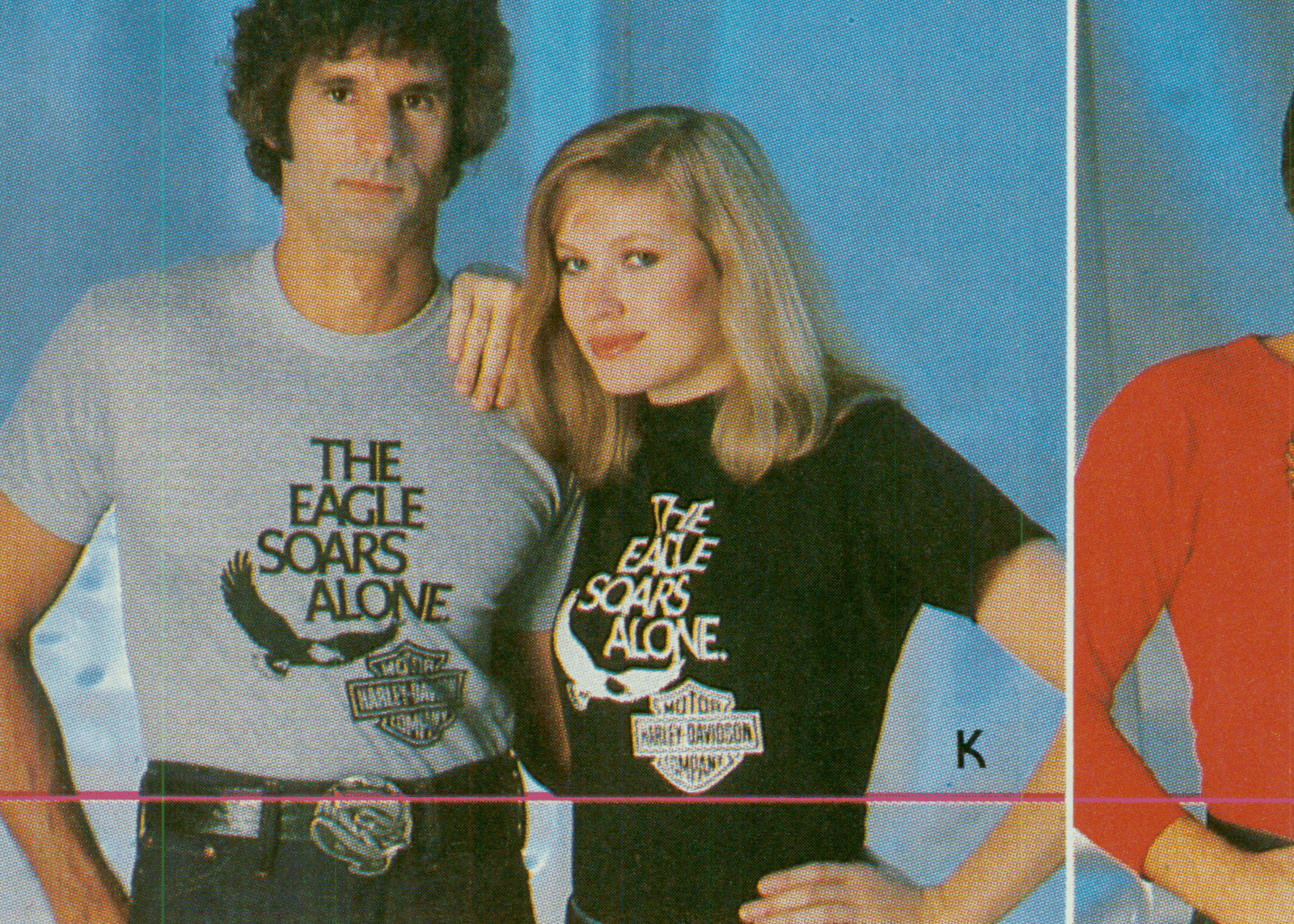 Two people pose in t-shirts in a magazine ad