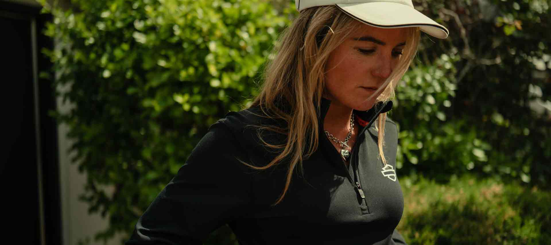 woman wearing a black shirt and white ballcap