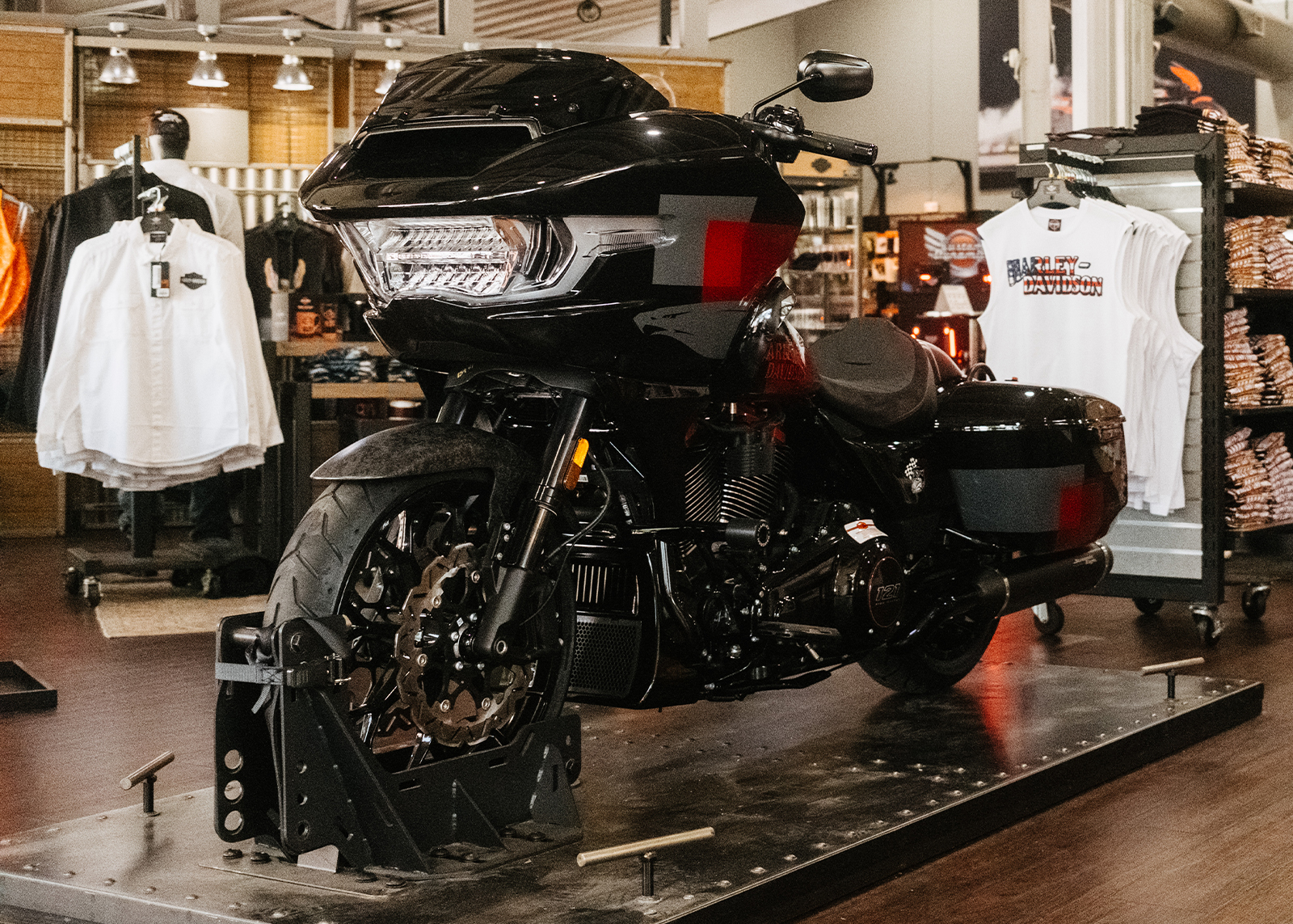 A Harley-Davidson Road Glide on display in Moonshine Harley-Davidson’s showroom with apparel and accessories in the background.