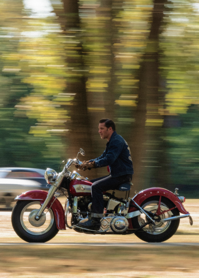 Tom Hardy staring as Johnny rides his motorcycle