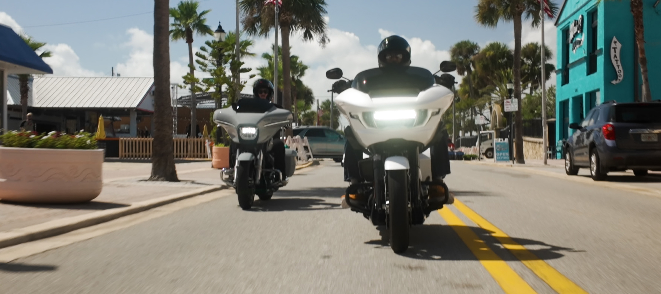 Two motorcycles cruise down main street in Daytona Beach, Florida