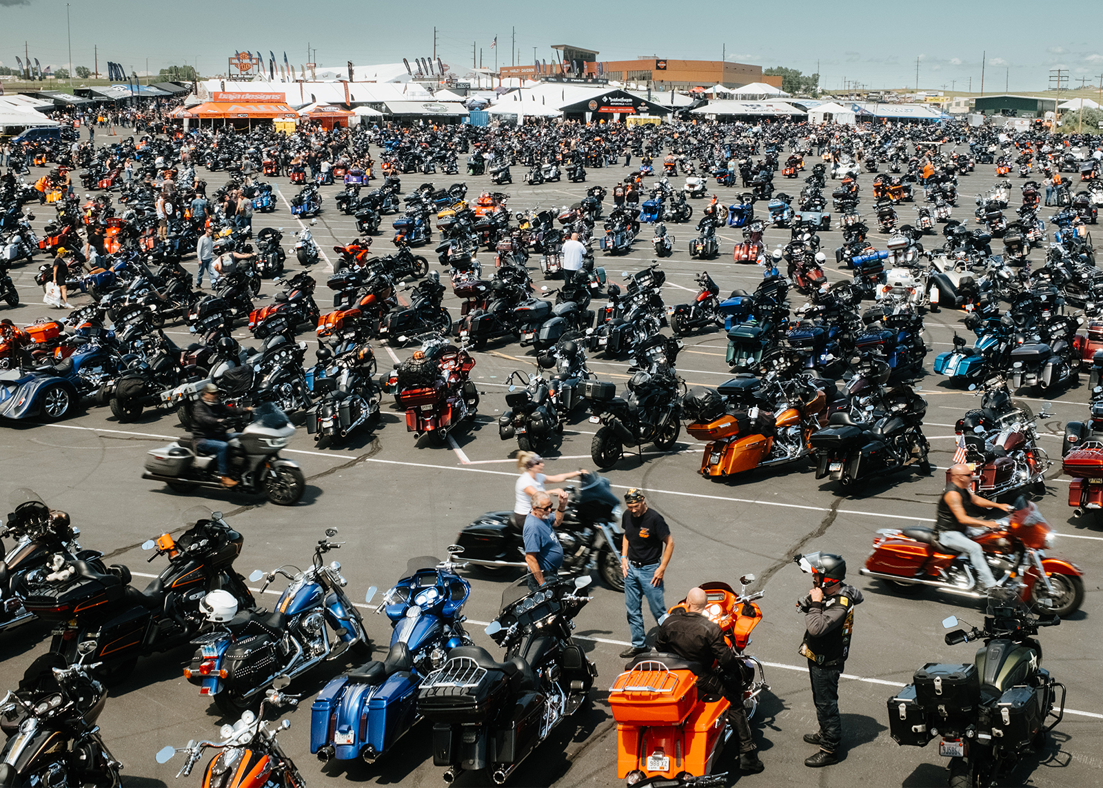 A massive lot packed with motorcycles and riders during the Sturgis Motorcycle Rally at Exit 55.