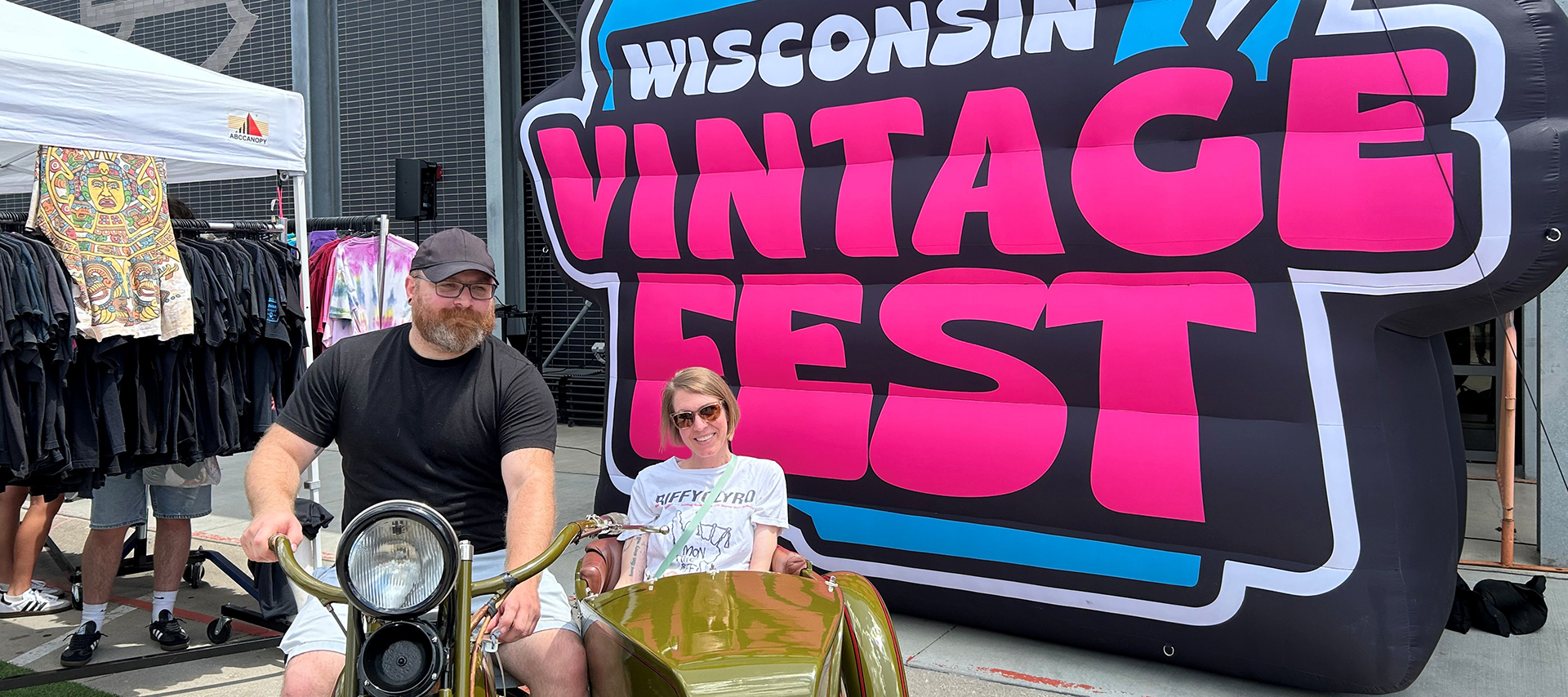 Visitors posing on vintage motorcycle at Wisconsin Vintage Fest