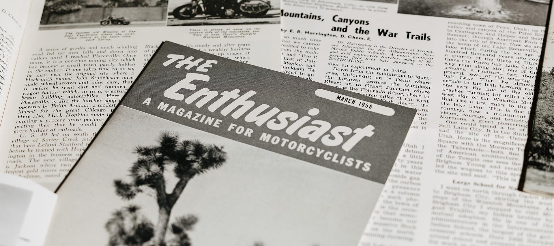 Modern photo taken of Eldred Harrington’s cover of the March 1956 issue of The Enthusiast shown atop other vintage pages and articles.