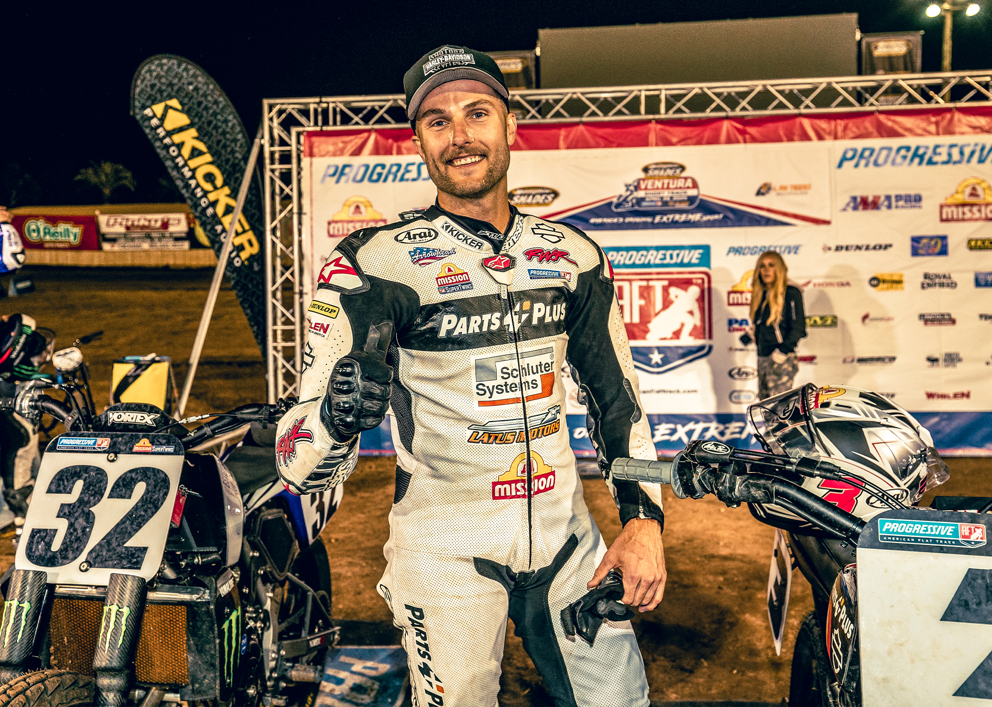 Briar Bauman smiles and gives a thumbs up as he stands in the podium area after a flat track race