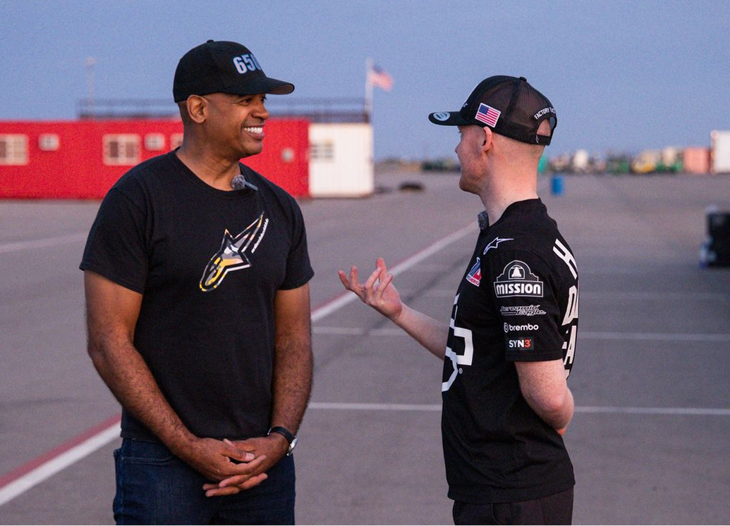 The author speaks with Bradley Smith at dusk after a day testing at the racetrack