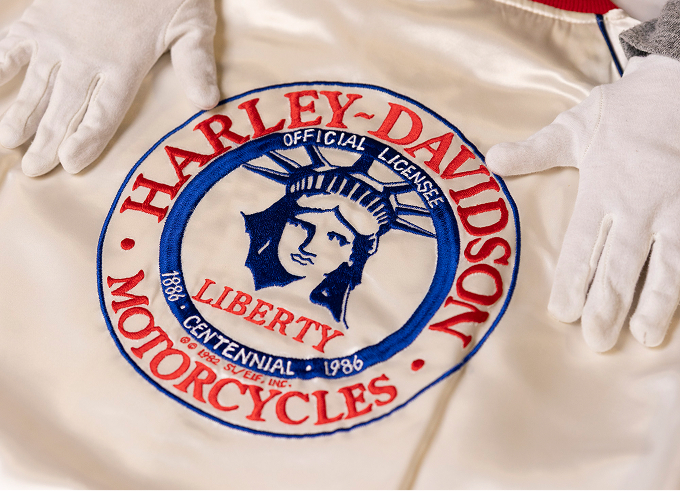 Harley-Davidson Liberty Centennial 1986 emblem embroidered on the back of a white satin jacket