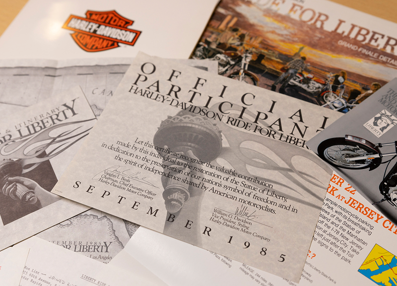 Ride For Liberty printed materials arranged on a surface with vintage Harley-Davidson imagery