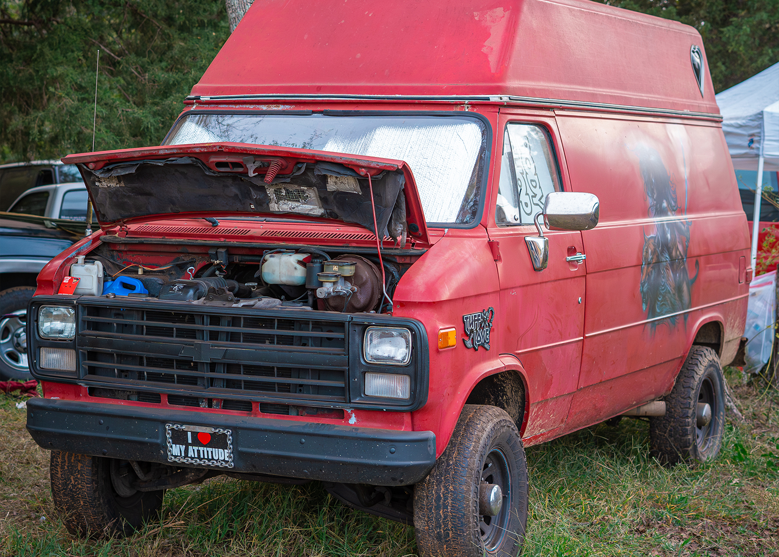 A red van with its hood open