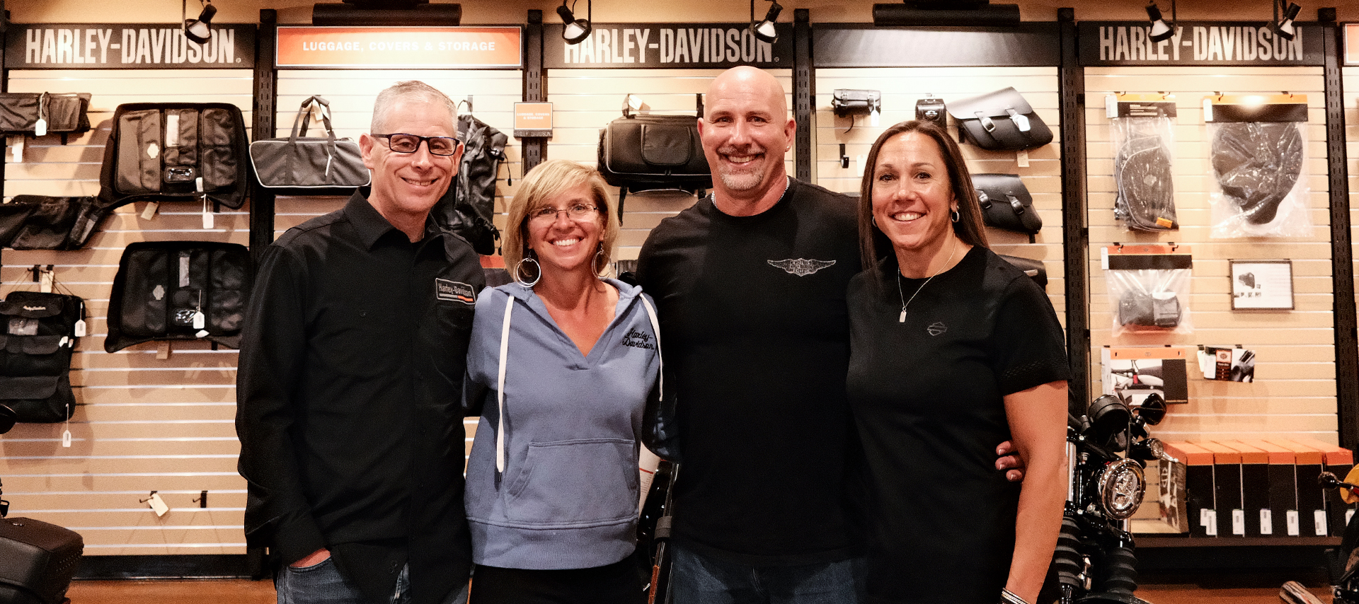 Four founding members of Classic Harley-Davidson pose for a photo inside the dealership.