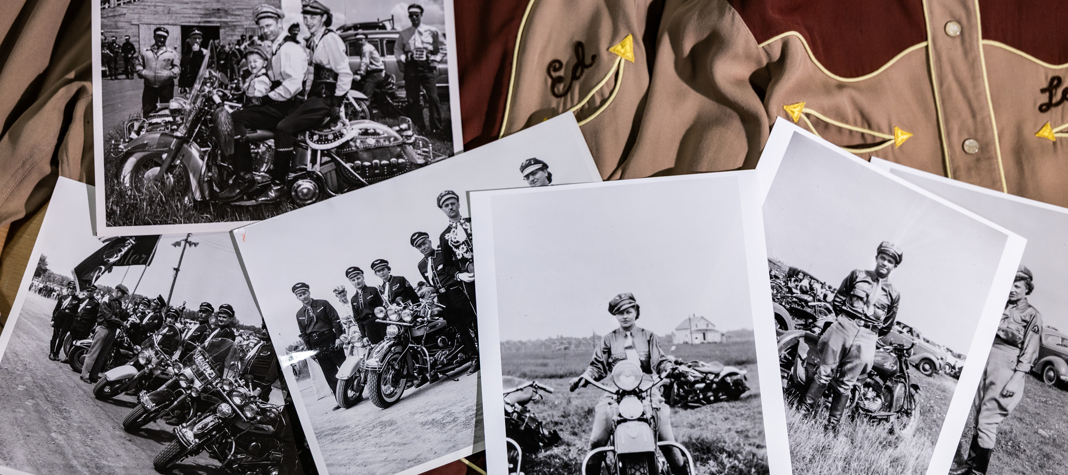 Vintage black and white photographs of motorcycle riders and events scattered across embroidered western shirts