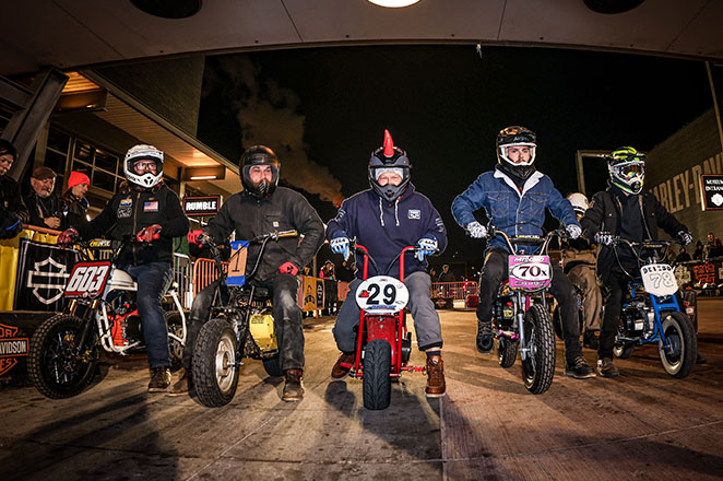 Riders on homemade motorcycles about to race