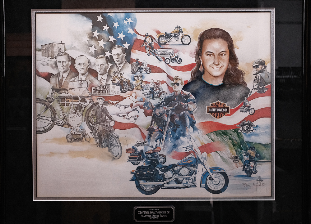 Framed Harley-Davidson illustration featuring historic riders, motorcycles, and American flag backdrop