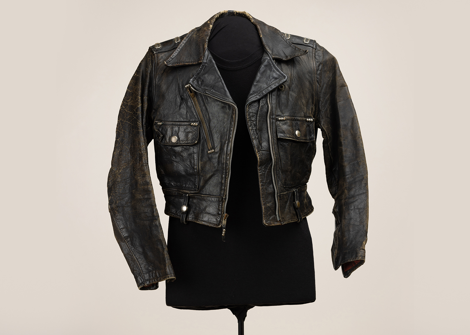 A vintage leather jacket on a mannequin