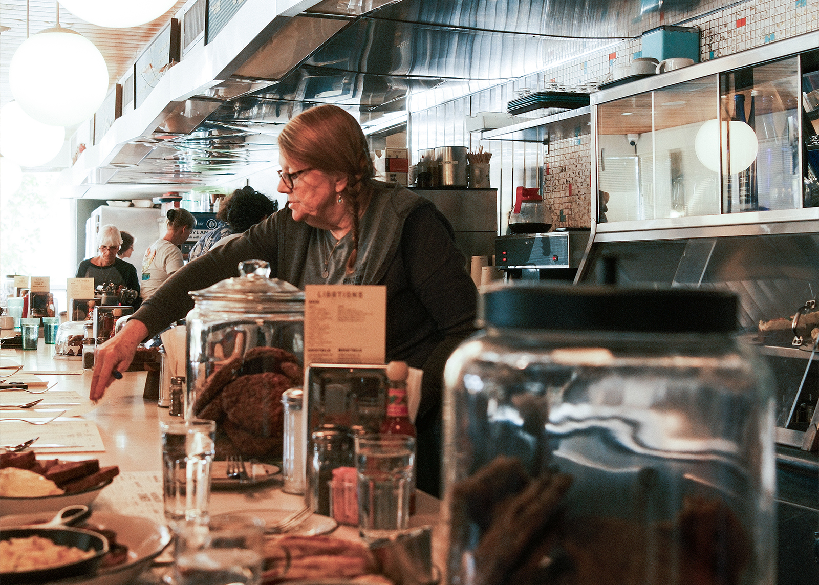 A woman working behind the counter at Phoenicia Diner.