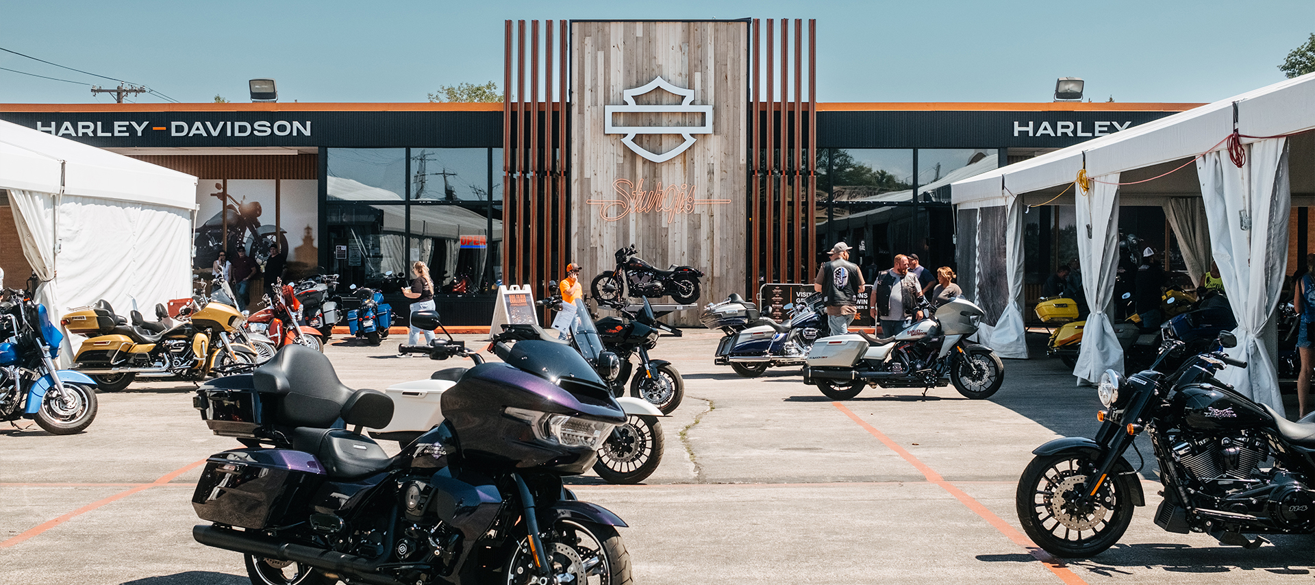 Rows of Harley-Davidson motorcycles displayed outside of Sturgis Harley-Davidson dealership during the Sturgis motorcycle rally event.
