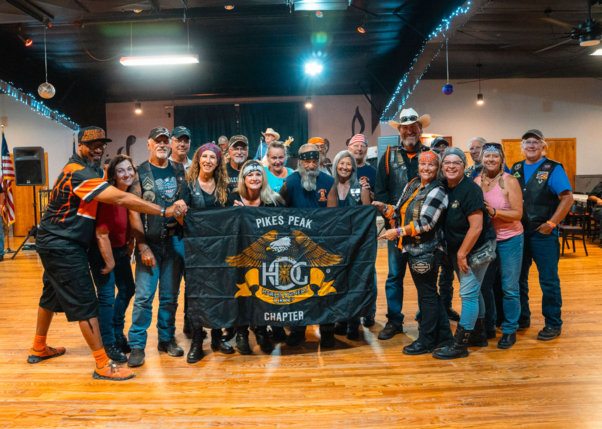 The Pikes Peak HOG Chapter poses for a group photo in a gymnasium