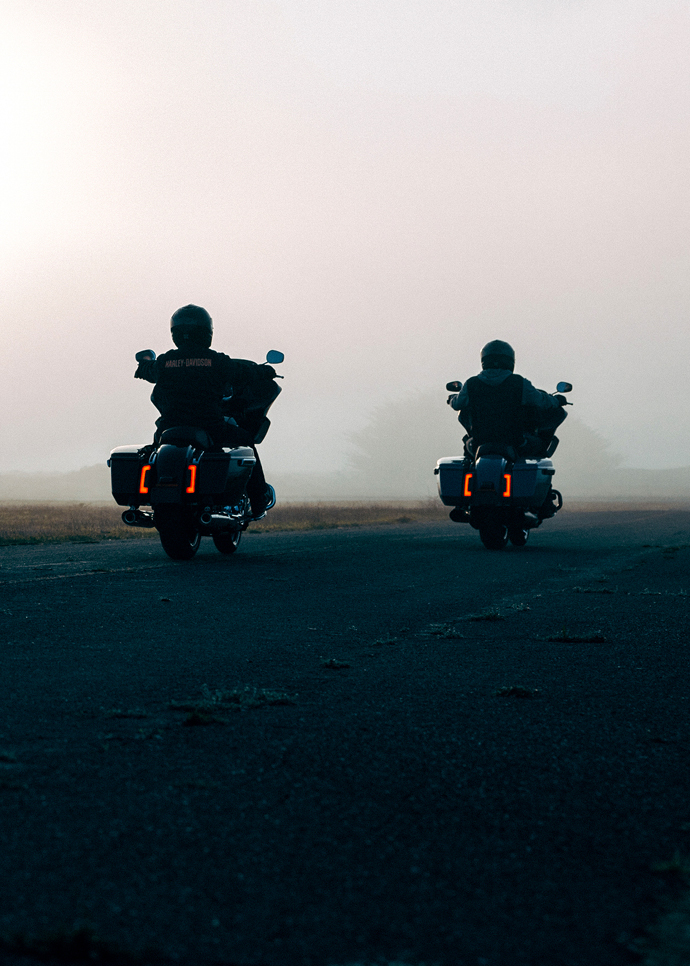 Cory Tran and Trung Tran ride on fog covered rode
