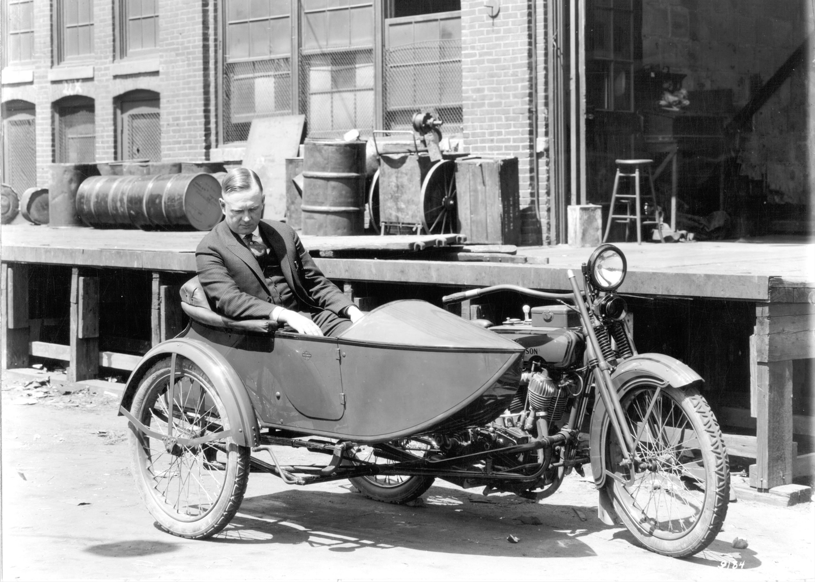 black and white photograph of a man sitting in a sidecar