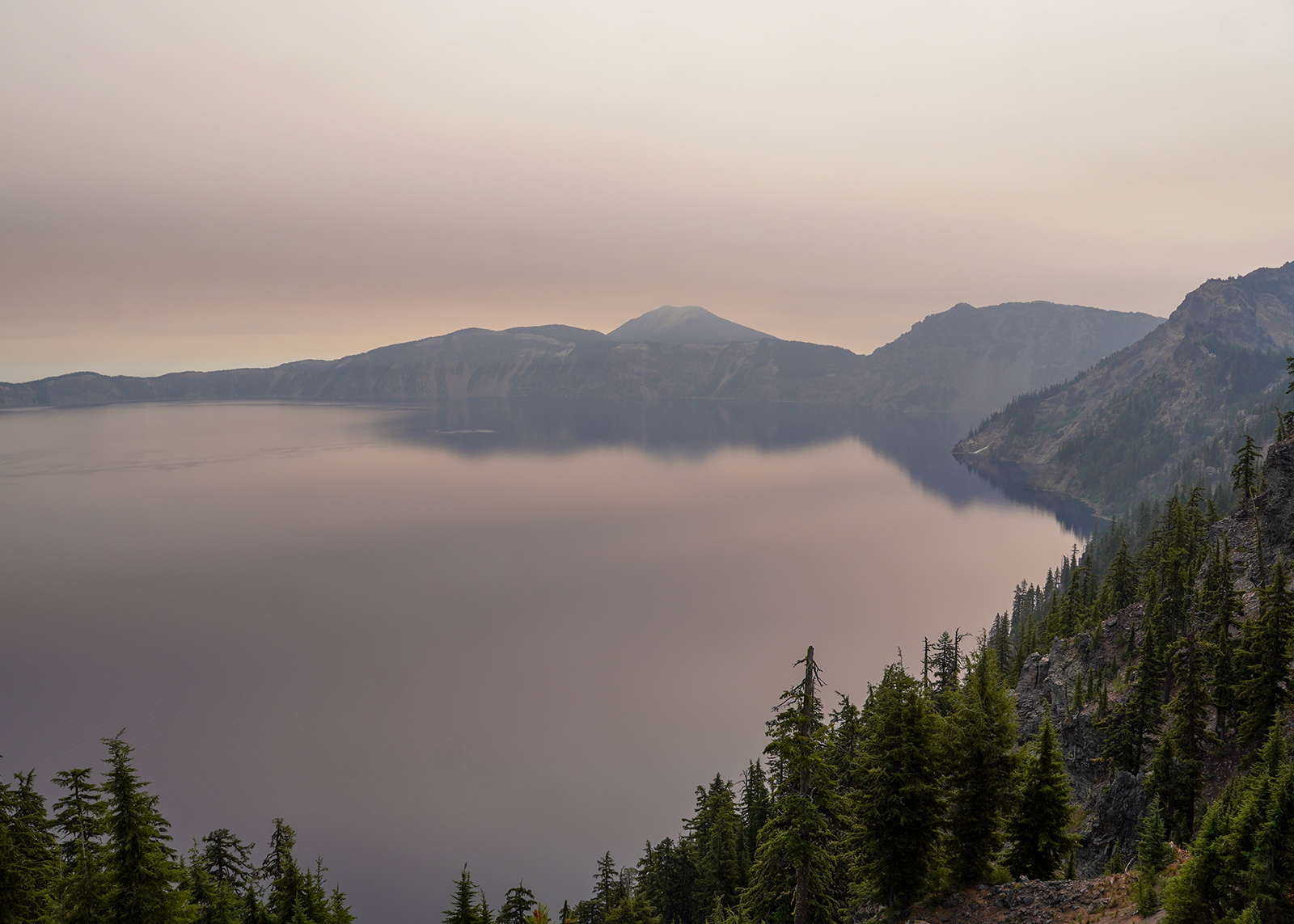 Photo of Crater Lake in Oregon with wildfire haze.
