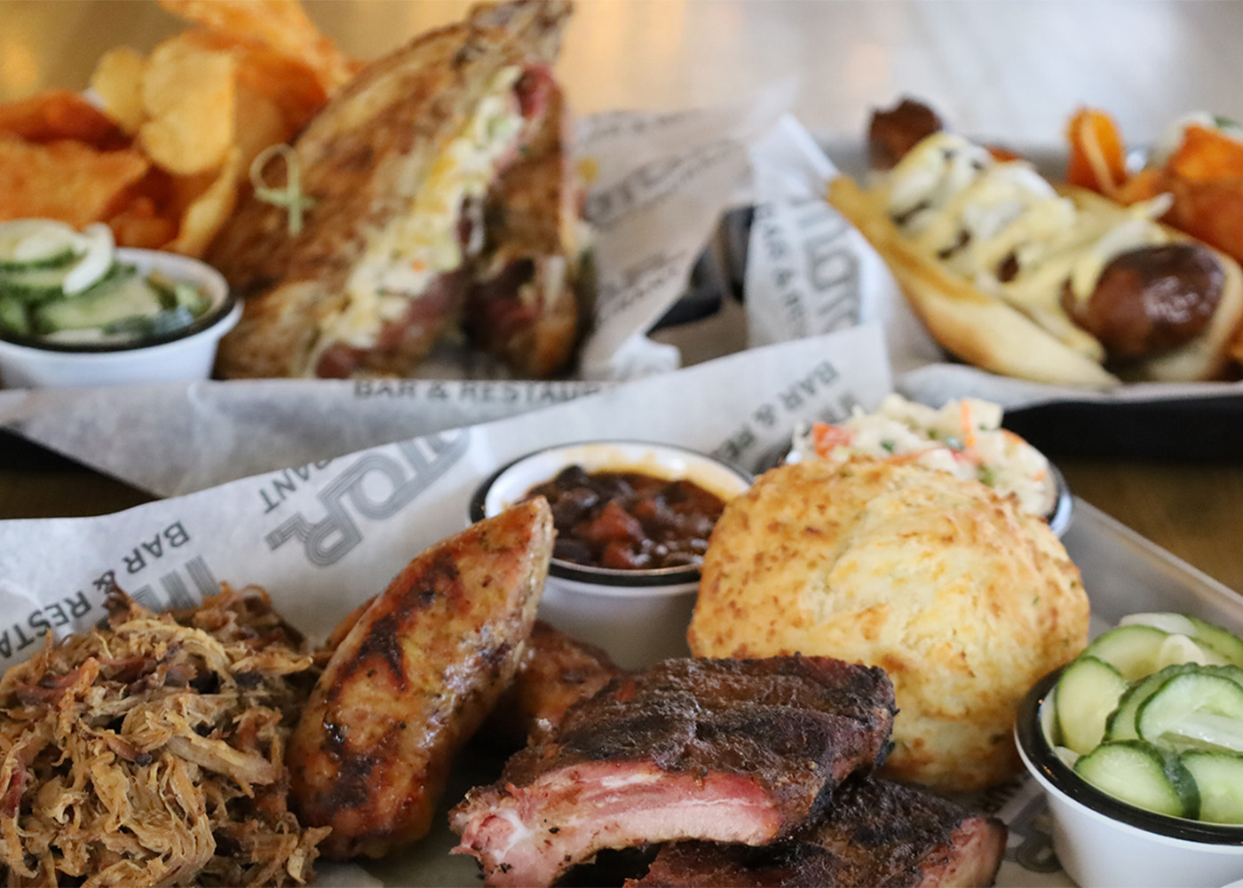 Barbecue meal with ribs, pulled pork, biscuit, and sides