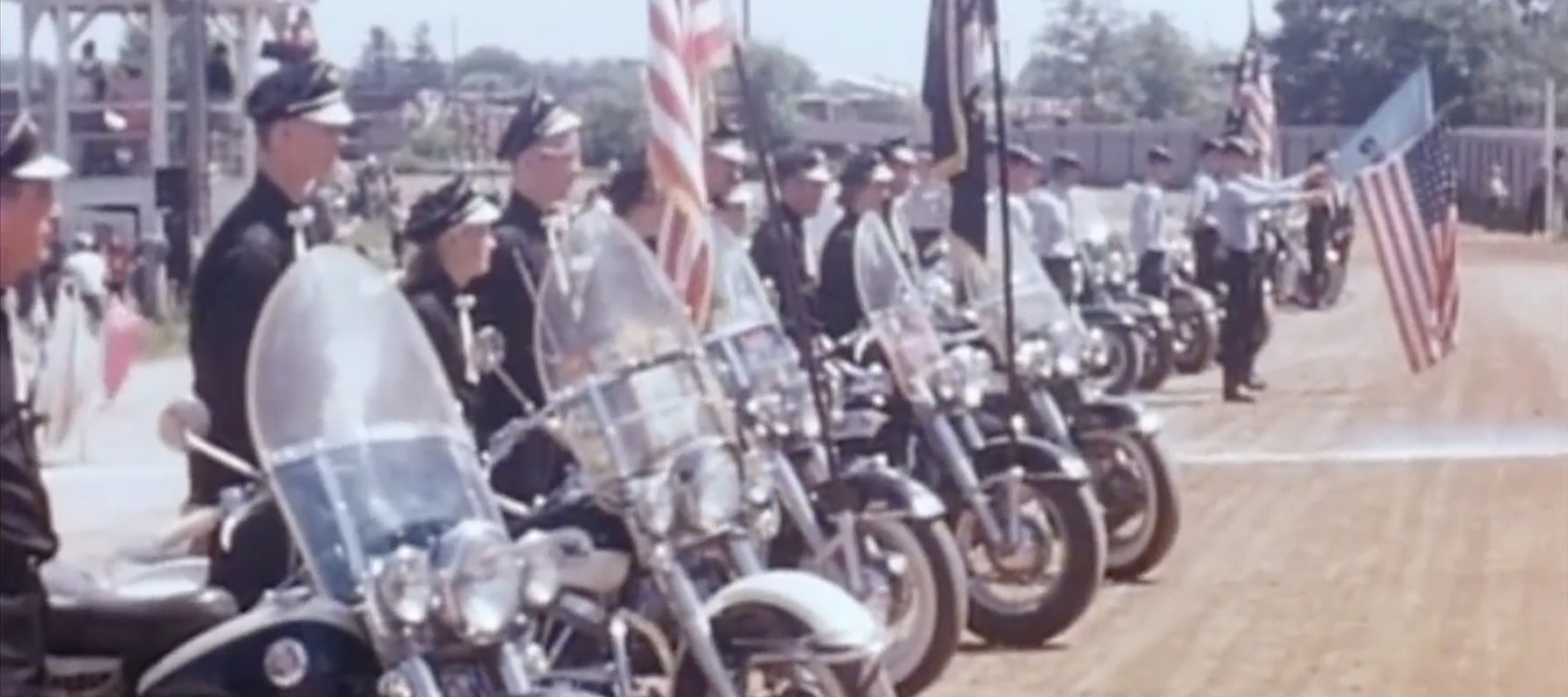 Video still of vintage footage of a motorcycle club meet