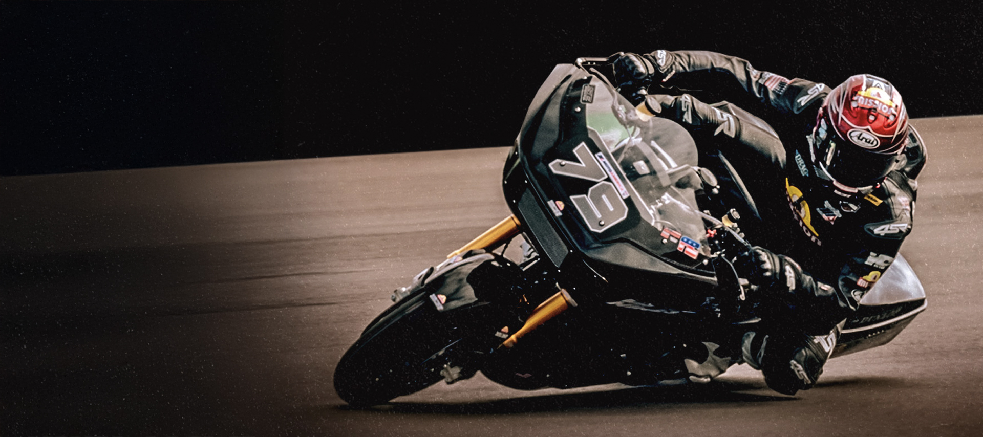 A rider with the number 79 on his bike takes a corner 