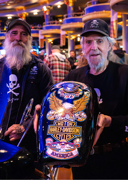 Artist Paul Smith holds the 1976 Bicentennial Edition tank he designed with colorful eagle themed graphics