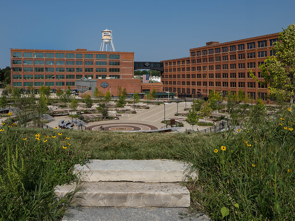 Harley-Davidson campus plaza between brick buildings and water tower
