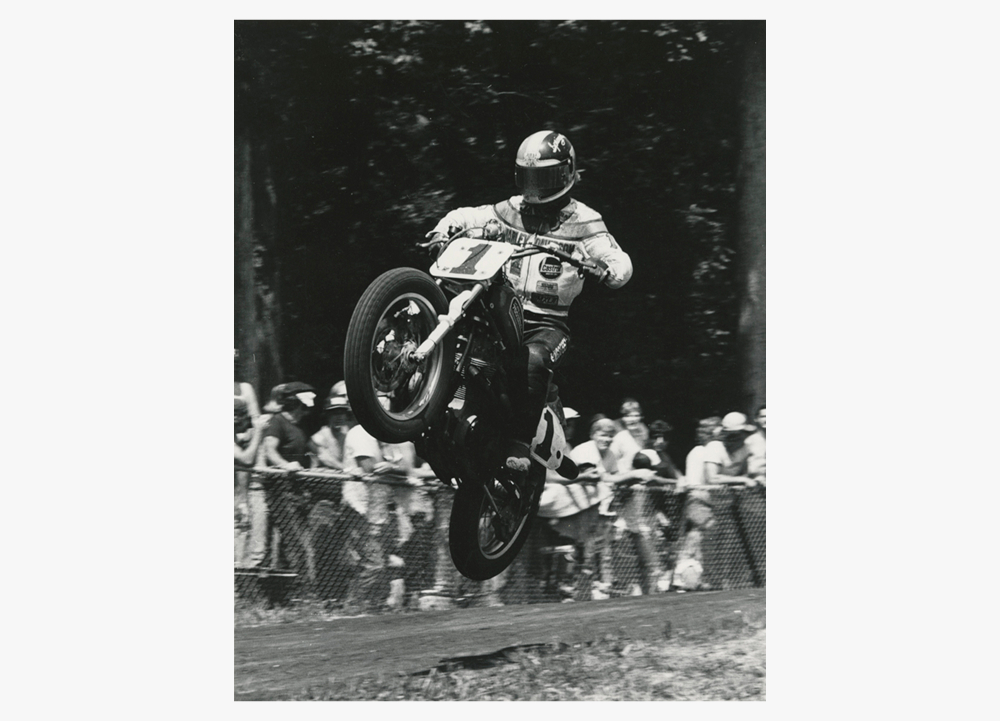 Number 1 rider Jay Springsteen launches over a jump while spectators gather near the course